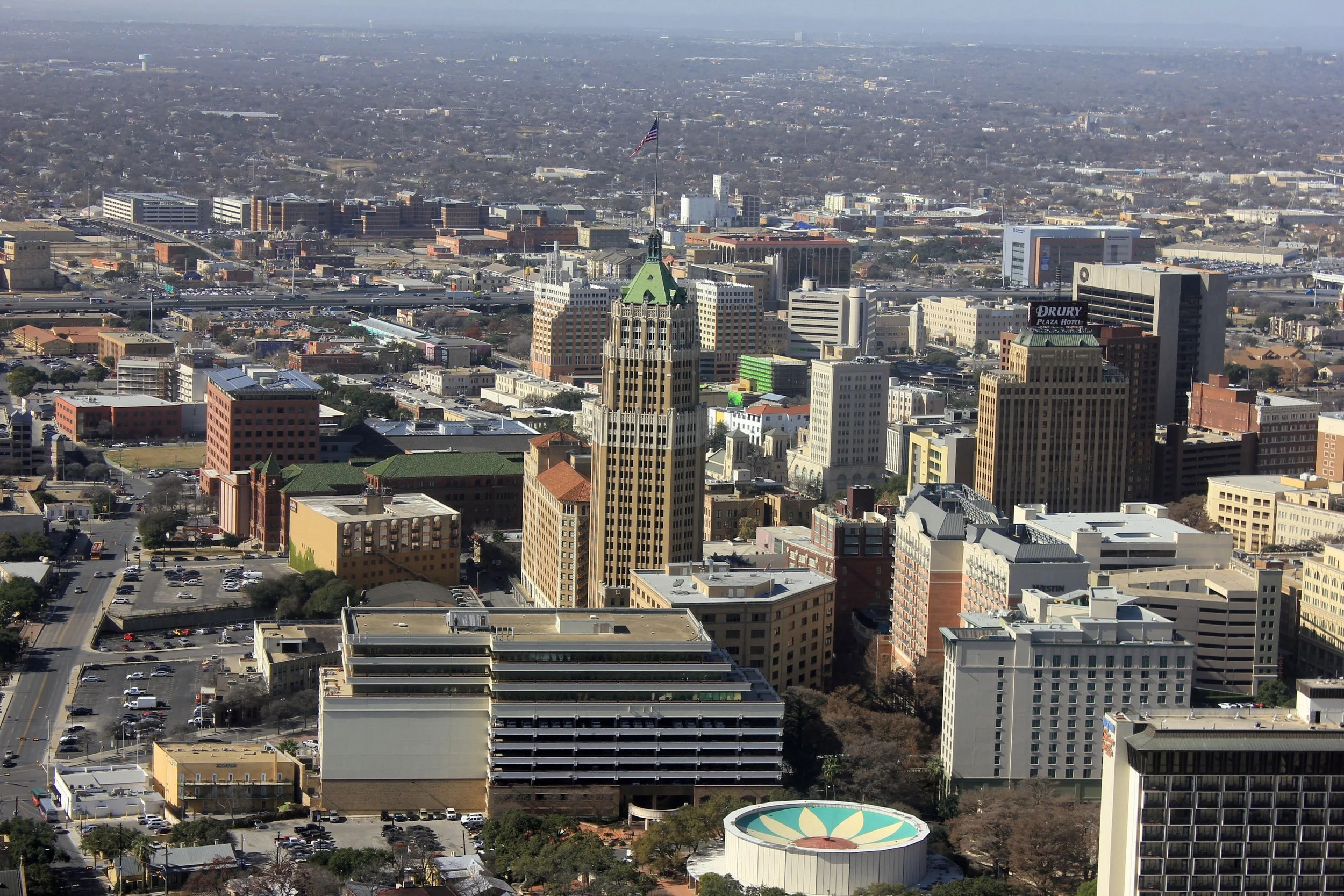 Aerial view of downtown San Antonio, Texas, with office towers and surrounding neighborhoods