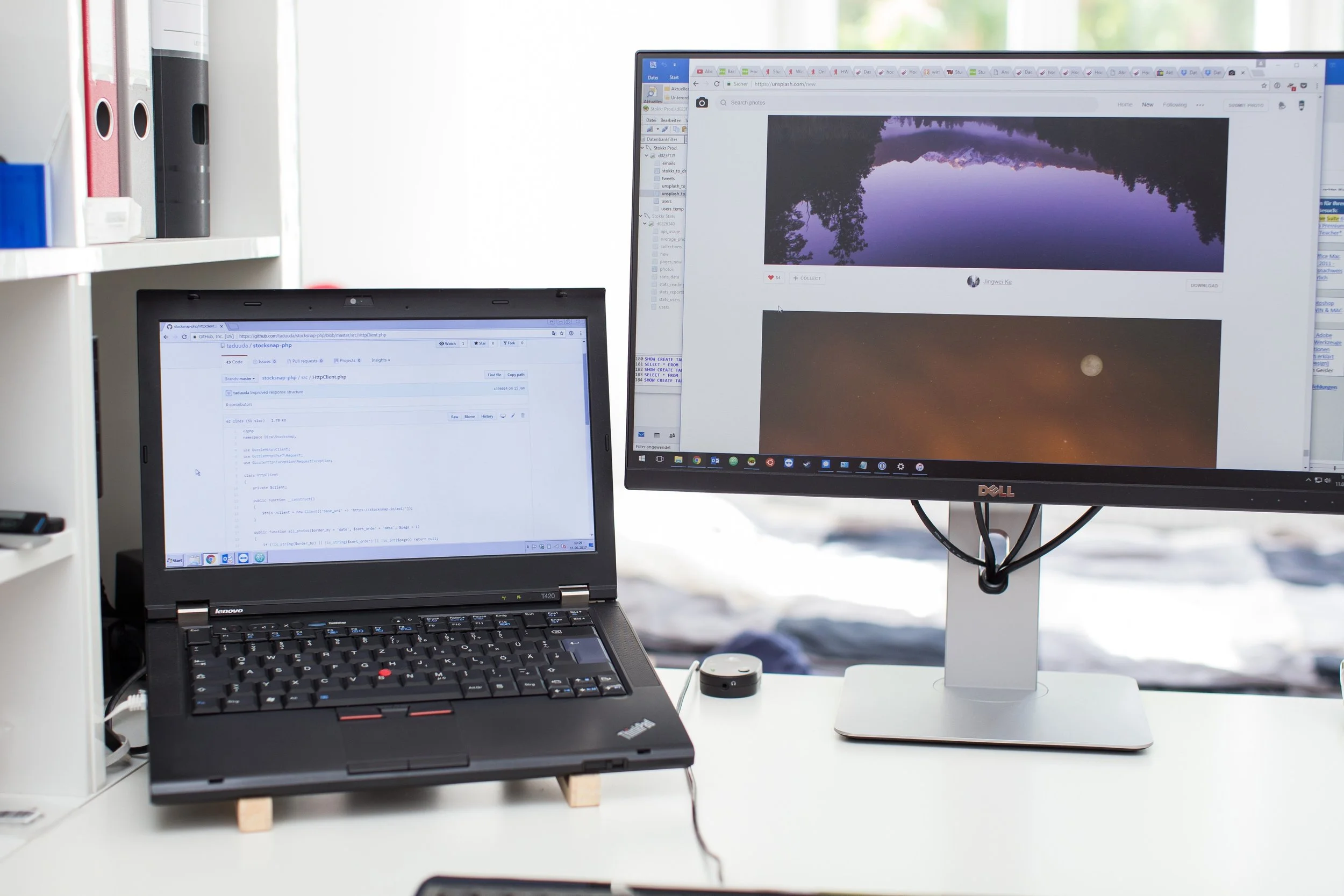 A laptop and an external monitor side by side on a white desk